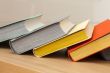 Vintage books in multi-colored covers on a table