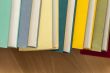 Vintage books in multi-colored covers on a table