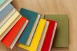 Vintage books in multi-colored covers on a table