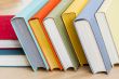 Vintage books in multi-colored covers on a table