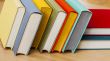 Vintage books in multi-colored covers on a table