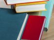 Vintage books in multi-colored covers on a table
