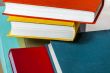 Vintage books in multi-colored covers on a table