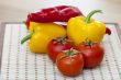 Large paprika of red and yellow color and fresh tomatoes