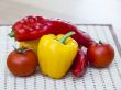 Large paprika of red and yellow color and fresh tomatoes