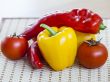 Large paprika of red and yellow color and fresh tomatoes