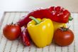Large paprika of red and yellow color and fresh tomatoes