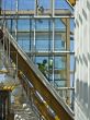 Workers wash a glass wall