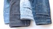jeans of various colors on a counter in shop