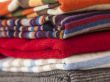 Pile of woolen jumpers of various colors