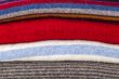 Pile of woolen jumpers of various colors
