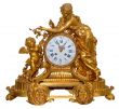 antique golden table clocks with cupid statuette