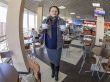 The woman bears two cups of coffee