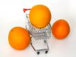 Large bright oranges in the cart for shopping