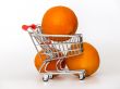 Large bright oranges in the cart for shopping