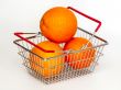 Bright large oranges in a basket for shopping