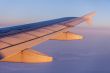 Flight at sunrise. The wing of the plane