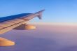 Flight at sunrise. The wing of the plane