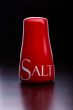 Red salt-cellar, pepper-box on dark background