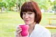 Woman with brown hair drinking tea