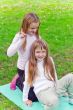 Two girls sitting on grass
