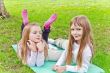 Two girls sitting on grass