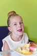 Eating girl with put out tongue