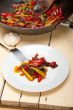 fried chili pepper and vegetable on a wok pan