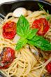 spaghetti pasta with baked cherry tomatoes and basil 