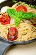 spaghetti pasta with baked cherry tomatoes and basil 