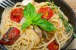 spaghetti pasta with baked cherry tomatoes and basil 
