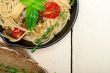 spaghetti pasta with baked cherry tomatoes and basil 