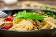 spaghetti pasta with baked cherry tomatoes and basil 