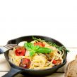 spaghetti pasta with baked cherry tomatoes and basil 