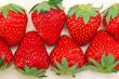 fresh organic strawberry over white wood