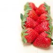 fresh organic strawberry over white wood
