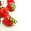 fresh organic strawberry over white wood