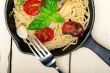 spaghetti pasta with baked cherry tomatoes and basil 