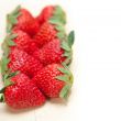 fresh organic strawberry over white wood