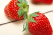 fresh organic strawberry over white wood