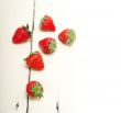 fresh organic strawberry over white wood