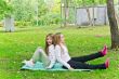 Two girls sitting on grass