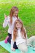 Two girls sitting on grass
