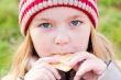 Girl in autumn eating cookie