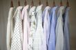 Assorted business shirts on hangers in a closet